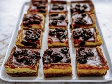 These bars are perfect for parties or potlucks. They are cooked in a lined 9-by-13-inch dish to make them easy to remove, and placing a pan of water on the bottom rack of the oven during the cooking guarantees a cheesecake with no cracks!
