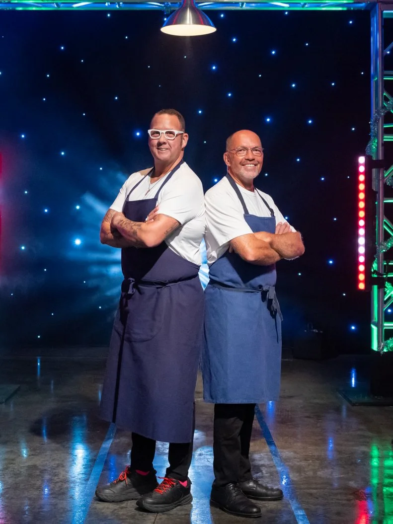 Contestants Graham Elliot and Giuseppe Tentori pose on set, as seen on Tournament of Champions Holiday, Season 1.