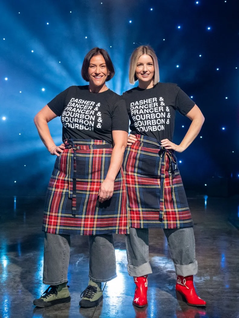 Contestants Sara Bradley and Damaris Phillips pose on set, as seen on Tournament of Champions Holiday, Season 1.