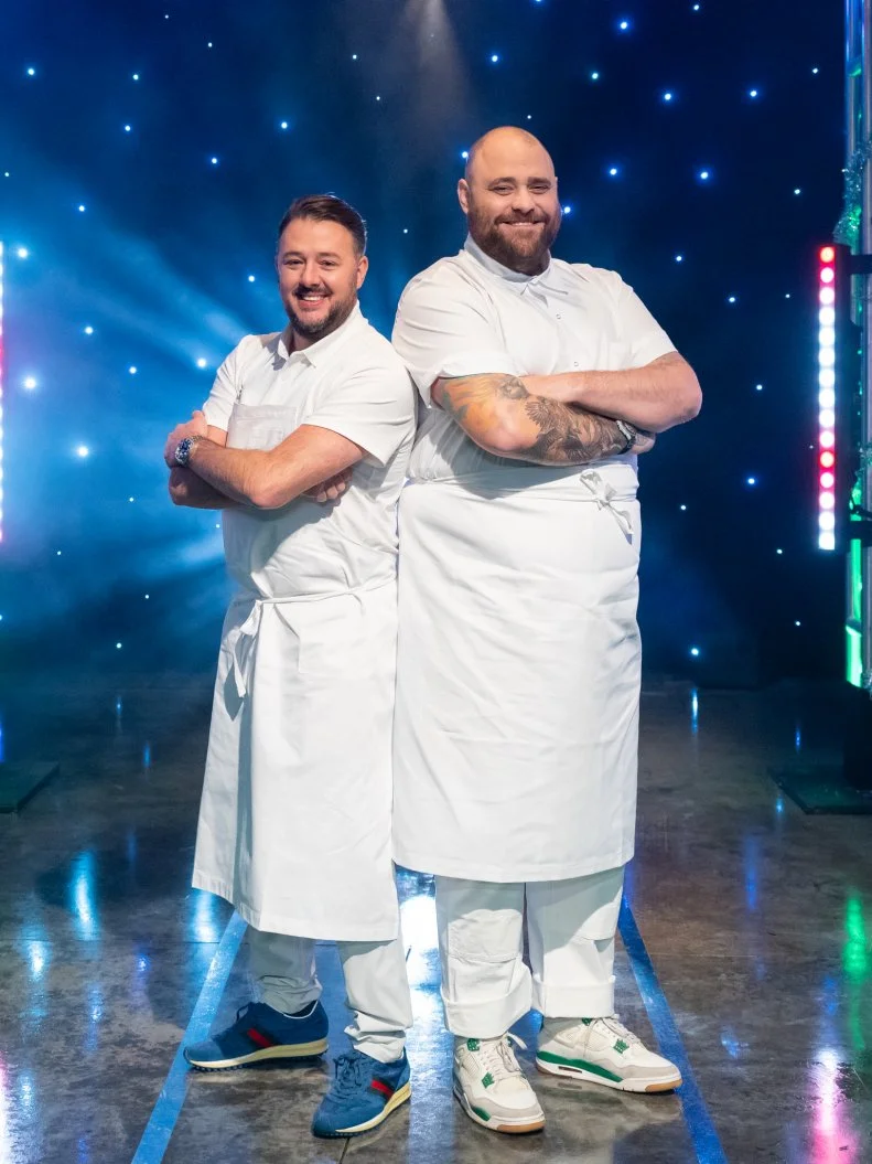 Contestants Adam Sobel and Christian Petroni pose on set, as seen on Tournament of Champions Holiday, Season 1.