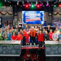 Host Guy Fieri with contestants Adam Sobel, Christian Petroni, Mei Lin, Nini Nguyen, Amanda Freitag, Aaron Sanchez, Jet Tila, Ashley Holt, Alex Guarnaschelli, Antonia Lofaso, Aarti Sequeira, Crista Luedtke, Jonathan Sawyer, Zac Young, Britt Rescigno, Sara Bradley, Damaris Phillips, Michael Voltaggio, Bryan Voltaggio, Maneet Chauhan, Stephanie Izard, Kevin Lee, Dale Talde, Shirley Chung, Sherry Yard, Marcel Vigneron, Tobias Dorzon, Marcus Samuelsson, Rachel Sherriffe, Graham Elliot, and Giuseppe Tentori, as seen on Tournament of Champions Holiday, Season 1.