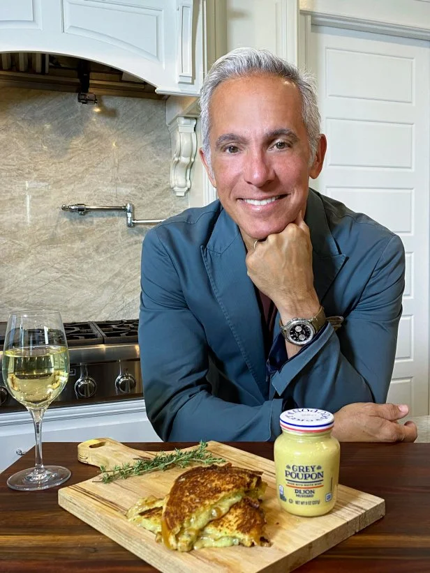 Geoffrey Zakarian posing with Brioche Grilled Cheese Beauty, as seen on Gold Plated.