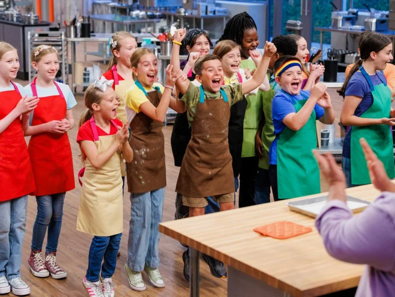 Contestants Harper and Holland Carroll, Cameron and Abby Bellezza, Genesis and Akbar Brooks, Emmett and Maci Sheets, Jovie and Lenore Byler, and Olivia Tatum, as seen on Baking Championship: Next Gen, Season 1.
