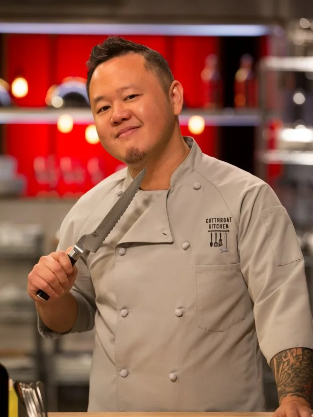 Chef Jet Tila threatens with a knife , as seen on Food Network's Cutthroat Kitchen, Season 3.