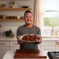 Jet Tila holding Sesame Chicken, as seen on Ready Jet Cook, Season 3.
