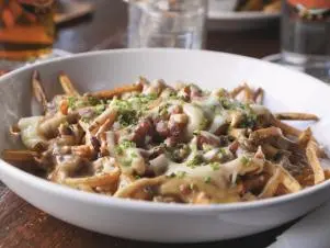 Poutine as prepared by Chef Cameron Wentworth at Hopleaf Bar in Chicago, Illinois, as seen on Food Network's Triple D Nation, season 8.