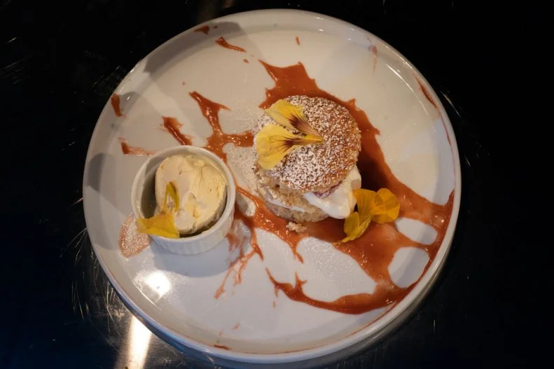 Contestant Chris Coleman's round 2 dish, Caramelized white chocolate biscuits with robiola ice cream, cream cheese meringue, and raspberry apricot (leather) puree, as seen on Alex vs. America, Season 2.