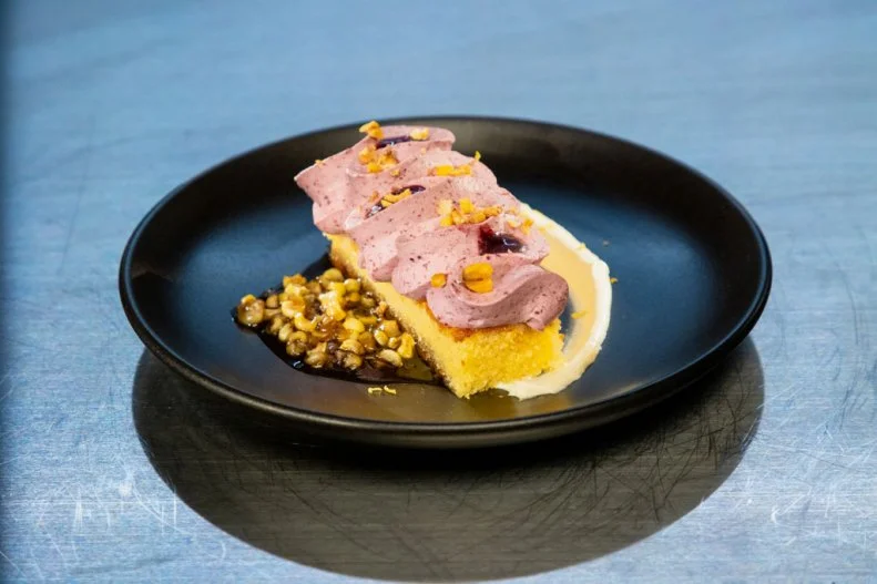 Contestant Jaclyn Joseph's round 2 dish, Almond cornmeal cake with bourbon blackberry creme fraiche chantilly, bourbon roasted corn anglaise and blackberry gel, as seen on Alex vs America, Season 3.