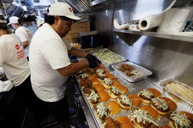 Park goers experience the Food Network x Graza Great Food Truck, as seen in Domino Park, Brooklyn on June 23, 2026. Attendees were served the Calabrian Fried Chicken Sandwich featuring Graza "Garlic" Aioli with a Creamy Cucumber Salad featuring Graza "Original" Olive Oil Mayo.