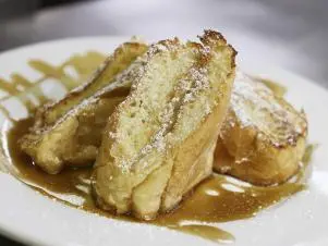 Bananas Foster French Toast as prepared by Chef Antoine Wilkerson at Surrey's Cafe in New Orleans, Louisiana, as seen on Food Network's Triple D Nation, season 8.