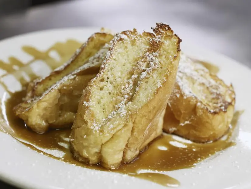 Bananas Foster French Toast as prepared by Chef Antoine Wilkerson at Surrey's Cafe in New Orleans, Louisiana, as seen on Food Network's Triple D Nation, season 8.