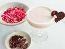 Indulge in a romantic twist on the classic Brandy Alexander with this frosty, ice cream-based version. Topped with delicate chocolate hearts, this decadent drink is perfect for celebrating love. Its creamy texture and rich flavors make it an irresistible treat to share on Valentine&rsquo;s Day, creating sweet moments and unforgettable memories.