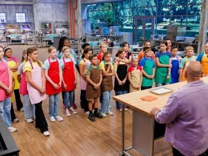 Hosts Duff Goldman and Kardea Brown do a demo bake for Contestants Taanvi and Kavya Bhenderu, Harper and Holland Carroll, Cameron and Abby Bellezza, Genesis and Akbar Brooks, Abigail and Kenneth Wolf, Leia and Kiera Sievert, Amelia and Clara Friesenhahn, Emmett and Maci Sheets, Jovie and Lenore Byler, Michael and Liam Nelson, Norah and Olivia Tatum, and Melody and Leila Nouri, as seen on Baking Championship: Next Gen, Season 1.