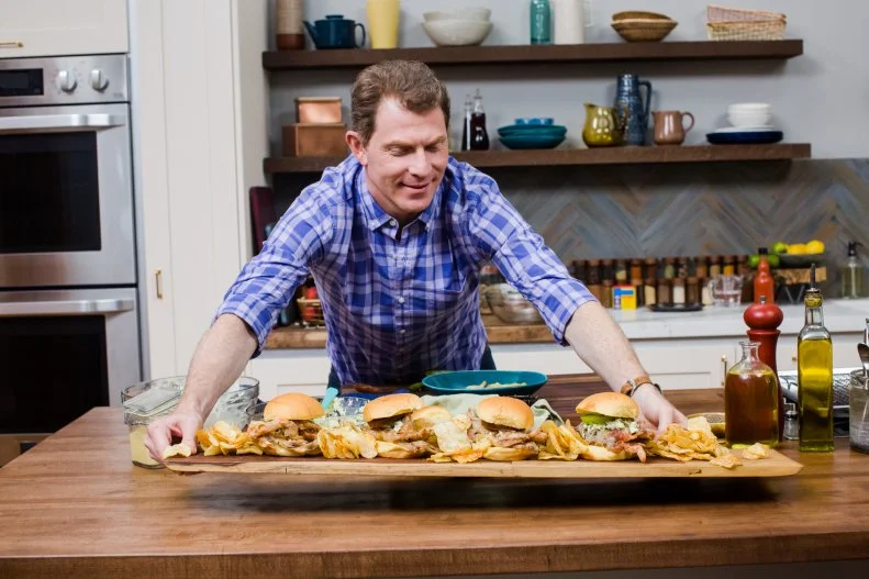 Chef Bobby Flay places tray of Crab Sandwiches down, as seen on Food Network's Brunch at Bobby's, Season 7.