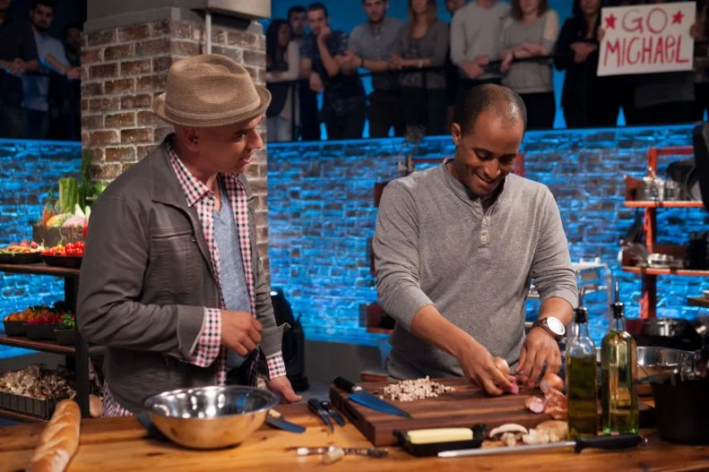 Special Guest Michael Symon visits contender Michael Jenkins as he races the clock to prepare his round one dish, as seen on Food Network's Beat Bobby Flay: Rematch, Season 6.