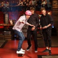 Contender Pablo Zitzmann and co-Hosts Michael Voltaggio and Tony Hawk watch chef Bobby Flay ride his skateboard on set of Beat Bobby Flay, Season 20.