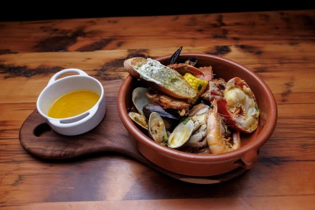 Chef Bobby Flay's Seafood Boil in Peruvian Yellow Chile Broth with Corn and Crispy Potatoes, as seen on Beat Bobby Flay, Season 36.
