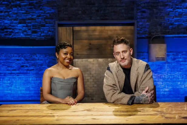 Co-hosts Quinta Brunson and Michael Voltaggio pose at the table, as seen on Beat Bobby Flay, Season 40.