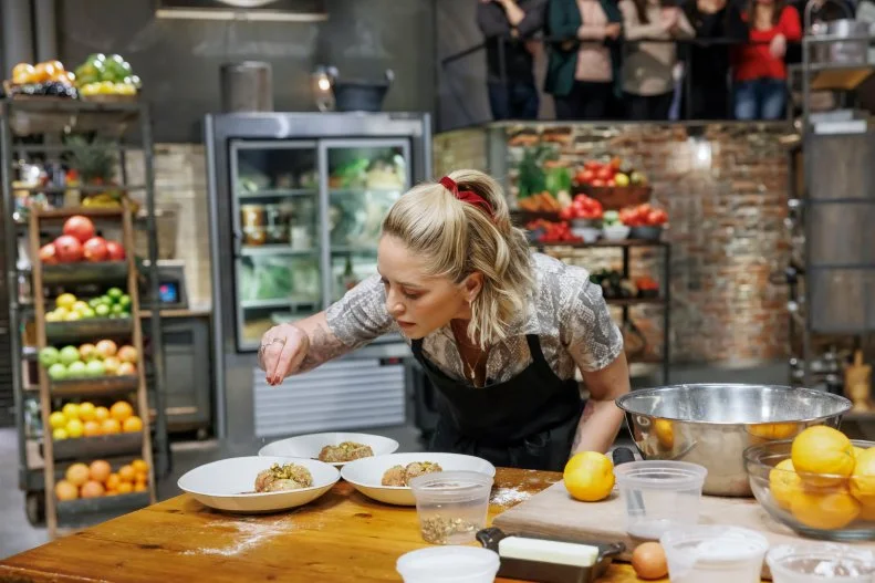 Contender Brooke Williamson puts the final touches on her dish, as seen on Beat Bobby Flay, Season 41. 