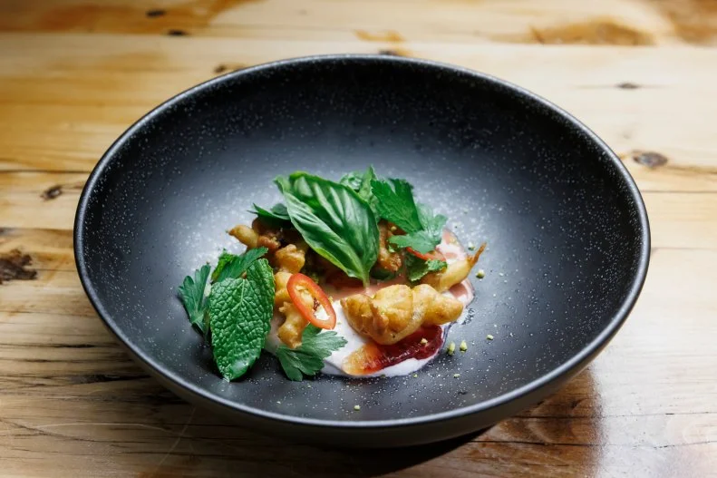 Contender Michael Voltaggio's pistachio funnel cake with blood orange ricotta and blood orange vinaigrette, as seen on Beat Bobby Flay, Season 41. 