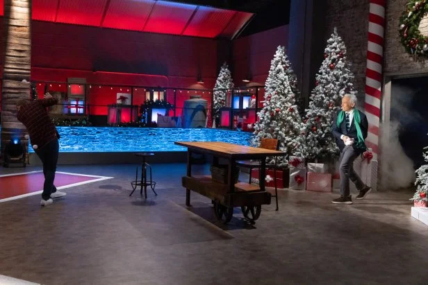 Co-host Geoffrey Zakarian pelts chef Bobby Flay with snowballs as he enters Kitchen Stadium, as seen on Beat Bobby Flay: Holiday Throwdown.