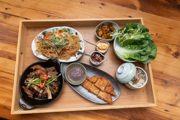 Contenders Esther Choi and Leah Cohen's Korean BBQ Ribeye with Seafood Japchae, Kimchi Pancake, Mushroom Rice, Cucumber Kimchi and Dipping Sauces, as seen on Beat Bobby Flay: Holiday Throwdown.