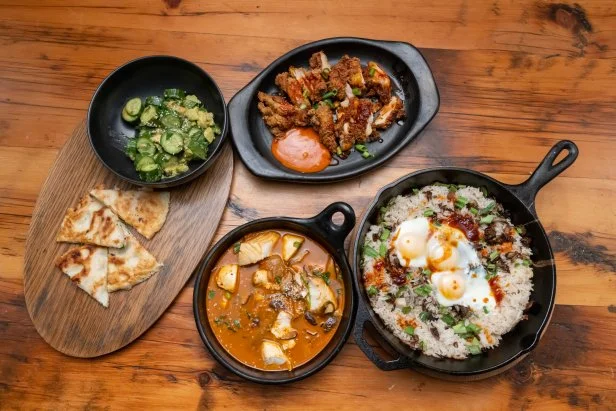 Chef Bobby Flay's Kimchi Halibut Stew with Crispy Rice, Crushed Avocado Salad, Korean Fried Chicken with a Gochujang Mayo Sauce and a Shrimp Squid Pancake, as seen on Beat Bobby Flay: Holiday Throwdown.