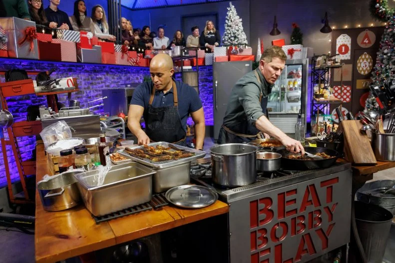 Contender Michael Jenkins and chef Bobby Flay work on their Round 3 dishes, as seen on Beat Bobby Flay: Holiday Throwdown, Season 4.