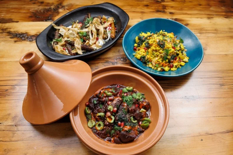 Chef Bobby Flay and contender Michael Jenkins' Lamb Tagine, Kashmiri Hot Sauce, Saffron Couscous and Spiced Carrots & Crispy Parsnips, as seen on Beat Bobby Flay: Holiday Throwdown, Season 4.