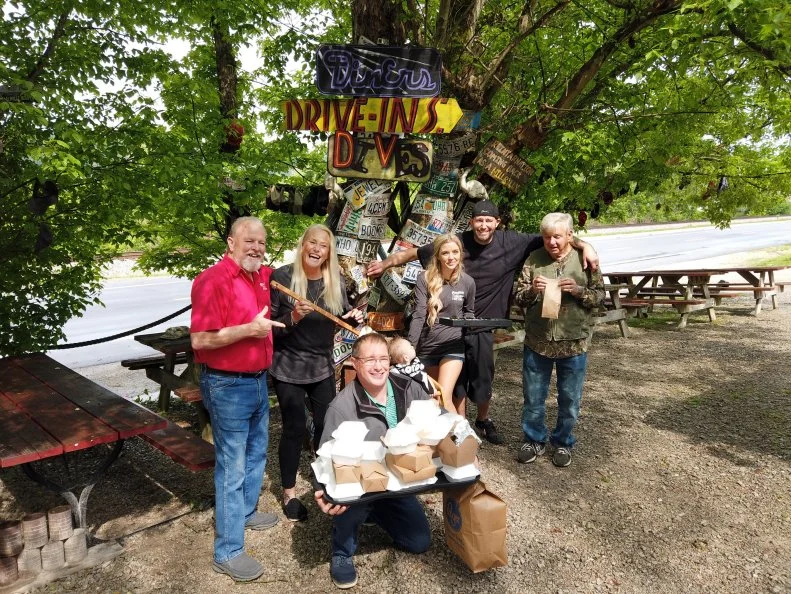 Chef and Owner Sharie Knight Posing with Family and Employees out front of Hillbilly Hot Dogs in Lesage, West Virginia as seen on Diners, Drive-Ins and Dives: Take Out, season 32.