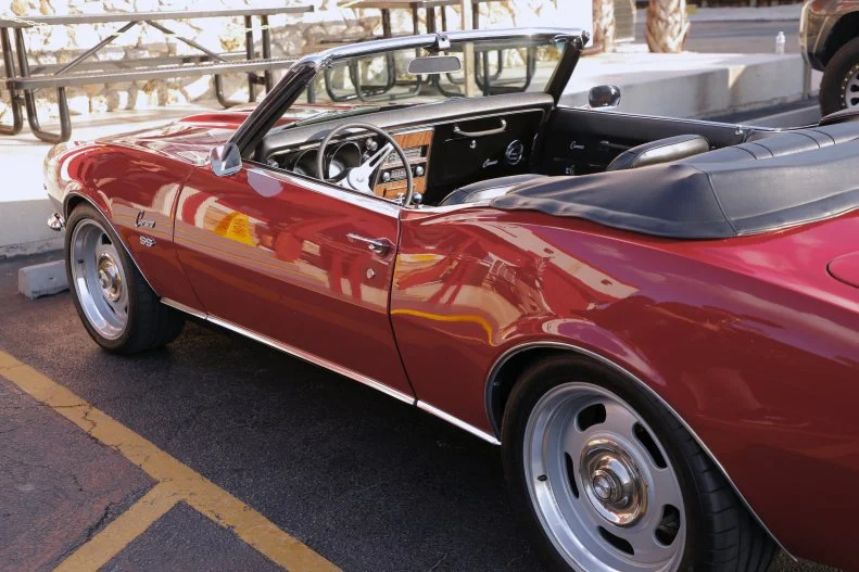 Guy Fieri's Camaro parked outside of Cracklin' Jacks in Naples, Florida, as seen on Food Network's Diners Drive-Ins and Dives, Season 41.