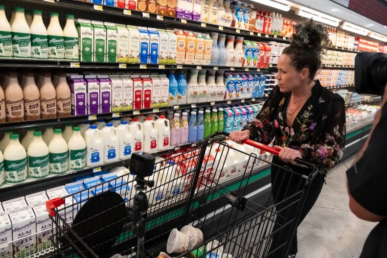 Contestant Stephanie Izard shops the dairy section for ingredients, as seen on Guy's Grocery Games, Season 41.
