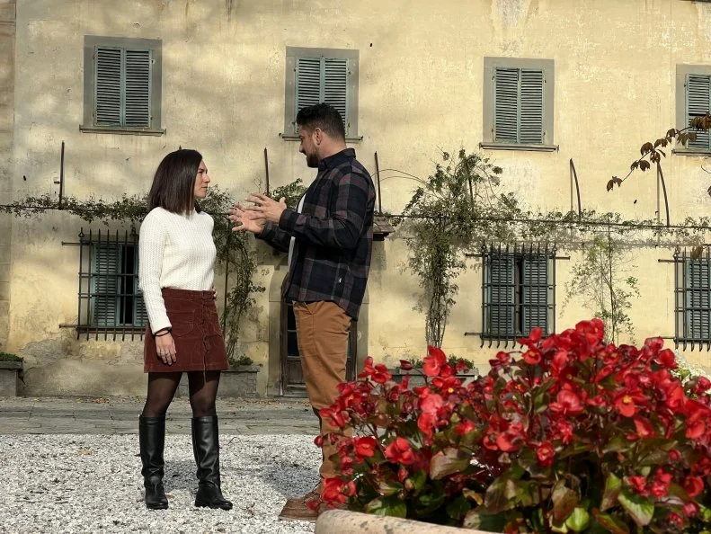 Exterior action shot of Agent Marta De Vito and contributor Chef Gabriele Bertaccini as seen on his property tour for House Hunters International (exterior).