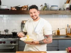 Host Gabe Bertaccini posed with Spaghetti Carbonara, as seen on Cook Like an Italian with Gabe Bertaccini, Season 1.