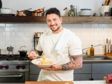 Host Gabe Bertaccini posed with Spaghetti Carbonara, as seen on Cook Like an Italian with Gabe Bertaccini, Season 1.