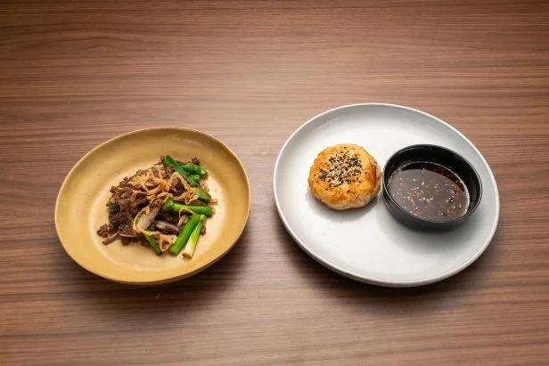 Chef Shirley Chung's Round 2 dishes, Mongolian style stir fry with beef and shallots, topped with crispy shallots, with Beijing meat pie filled with ground beef and shallots, with a shallot chili crisp, with black vinegar dressing chef, as seen on Bobby's Triple Threat, Season 3.