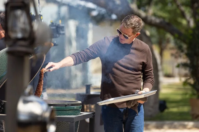Host Bobby Flay helps prepare Team Brawl dish, as seen on BBQ Brawl, Season 7