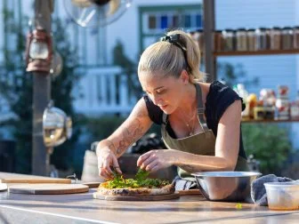 Host Brooke Williamson prepares Advantage Challenge dish, as seen on BBQ Brawl, Season 7