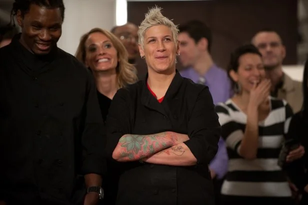 Contestants Malcolm Mitchell, Kara Sigle and Michele Ragussis of Team Bobby watching teams give their restaurant presentations for the Star Challenge "Restaurant Impossible" as seen on Food Network Star, Season 8.