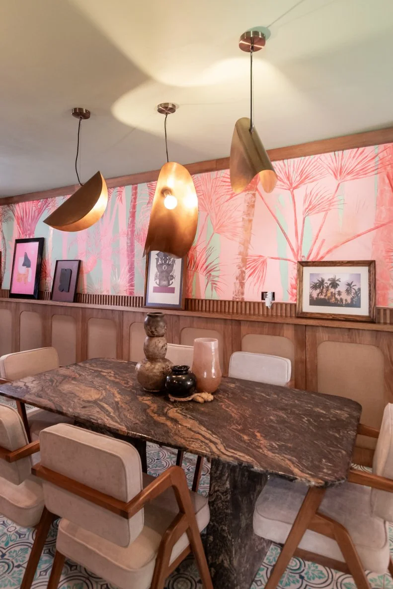 Rick is a huge proponent of pendant lamps in his home that often incorporate organic materials like wood and clay. He likens the effect to jewelry for the home. His dining room, which flows into the downstairs kitchen is defined by a gorgeous local park where he and Chico like to walk. Like many of the artworks in the home the piece was commissioned for the home by an artist friend of Rick's.