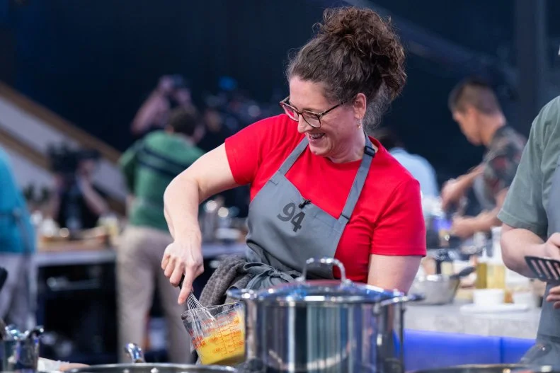 100 Cooks contestant Susie Weinrich beating eggs