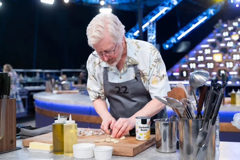 100 Cooks contestant Scott Russell minces garlic