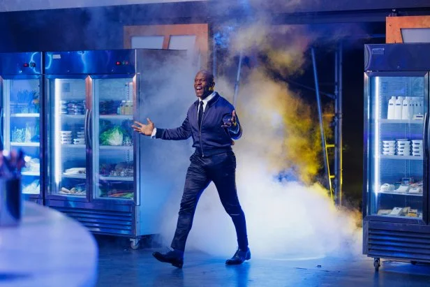 100 Cooks host Terry Crews walking into the competition kitchen