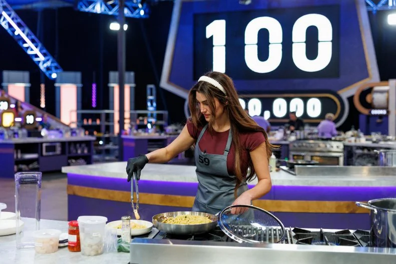 100 Cooks contestant Sherry Shabbagh making a noodle dish