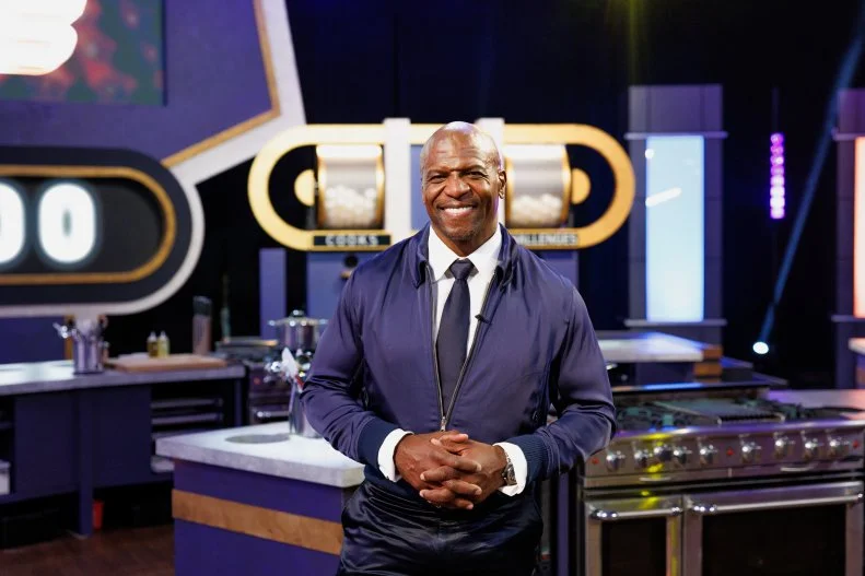 Host Terry Crews posed in kitchen, as seen on 100 Cooks, Season 1.