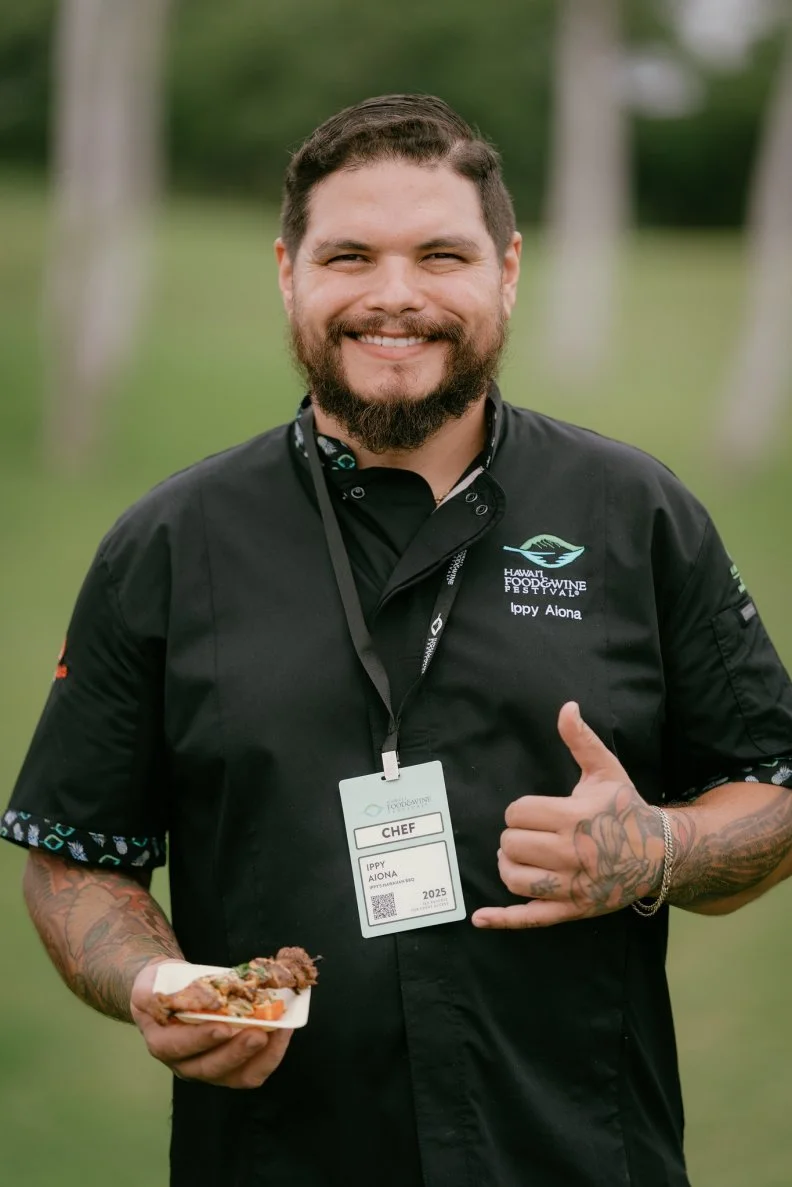 Ippy Aiona holding a plate at the Hawaii Food and Wine Festival
