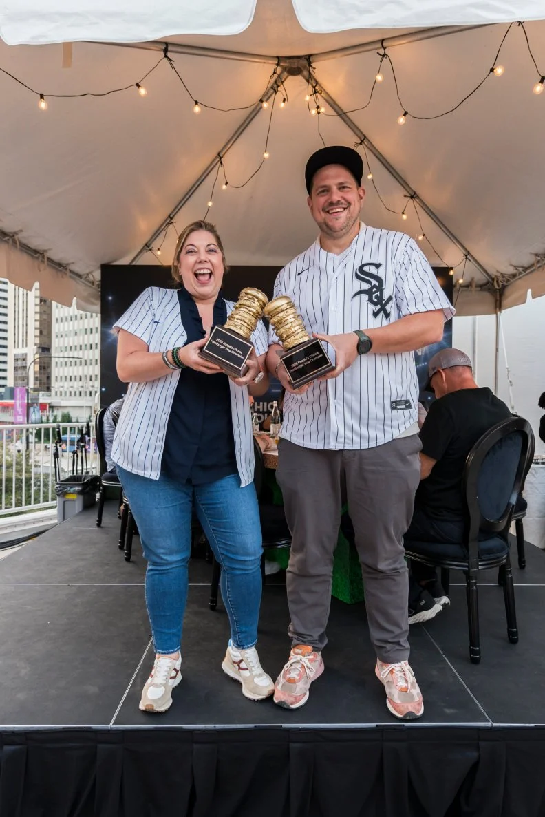 Sarah Grueneberg and Joe Flamm standing under a tent at the Chicago Gourmet food festival