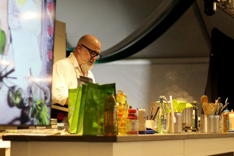 Chef Andrew Zimmern prepares a dish at the 2025 Atlanta Food & Wine Festival