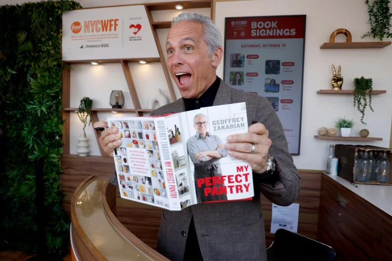 Geoffrey Zakarian signing books at the Food Network NYC Wine & Food Festival.