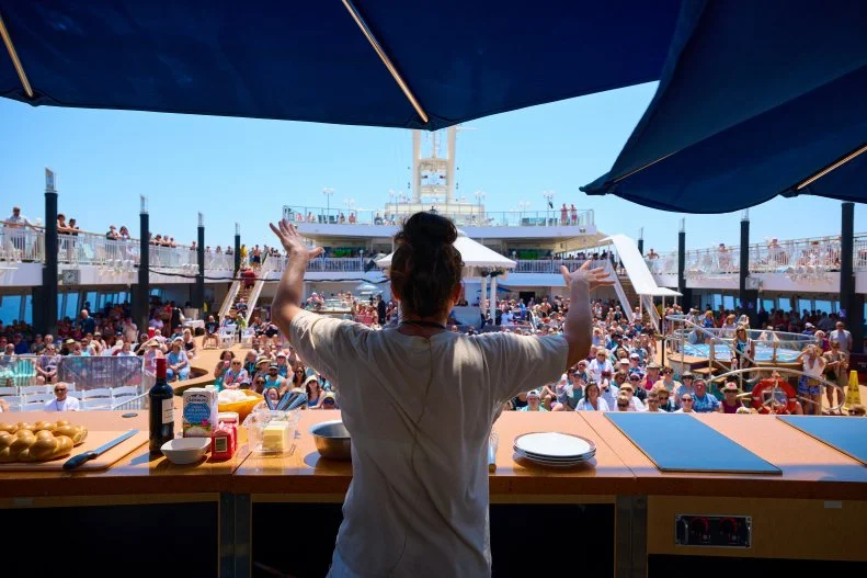 A chef faces the crowd of attendees onboard at Chefs Making Waves